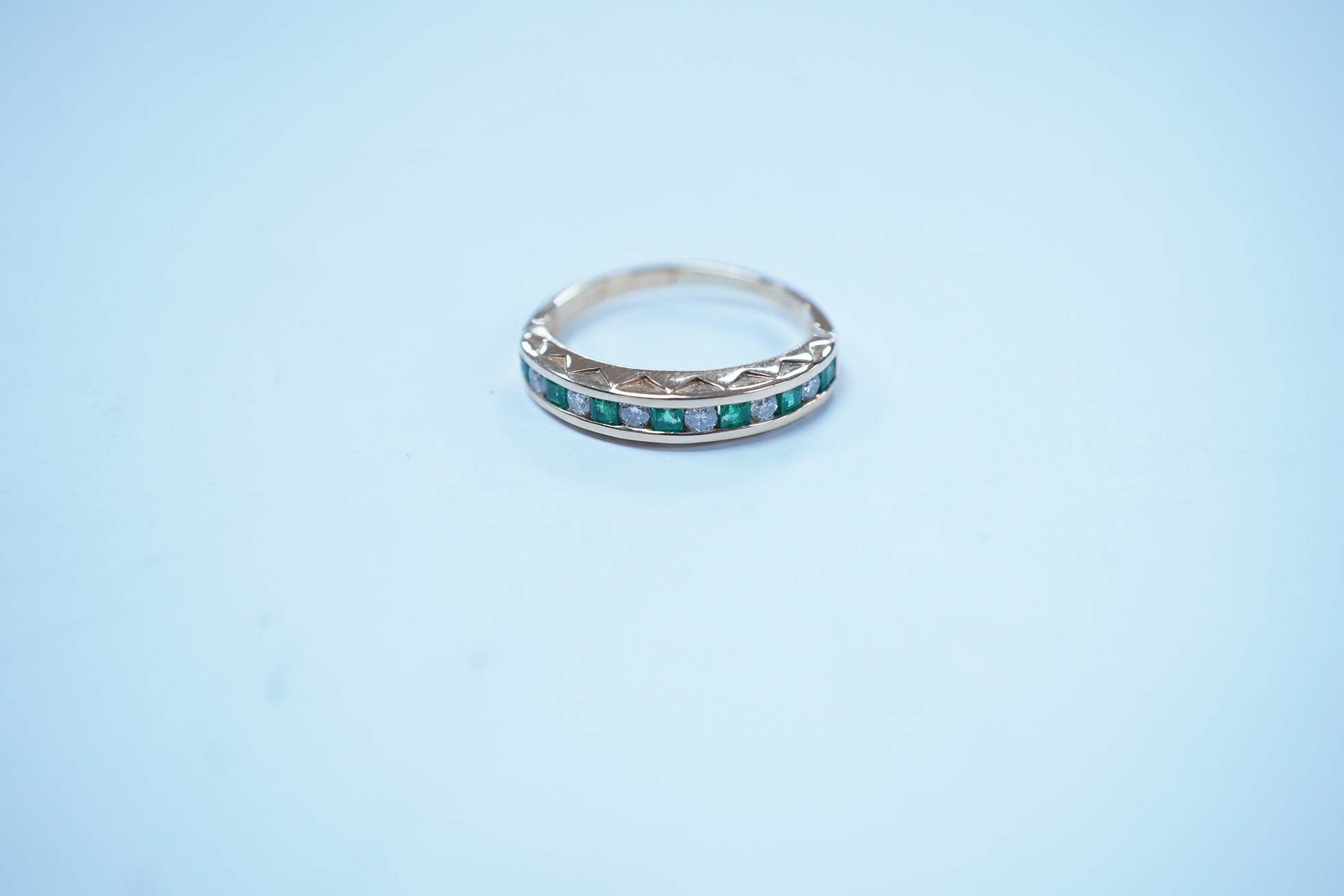 A modern 18k, seven stone emerald and six stone diamond set half hoop ring, size F/G, gross weight 2.4 grams. Condition - poor